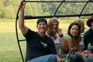 a group of people sitting in the grass