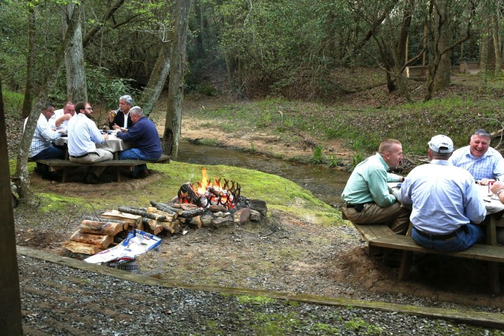 a group of people sitting at a picnic table